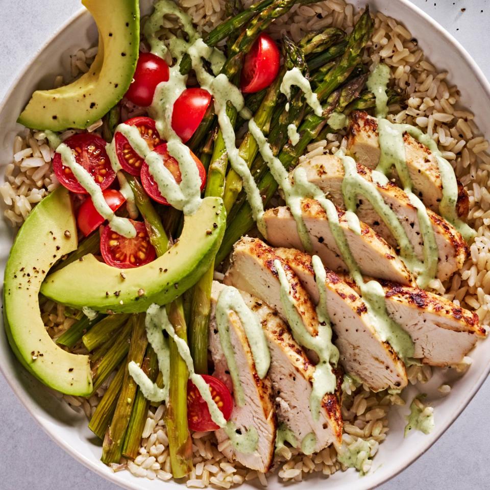 goddess bowls with chicken, asparagus, avocado and tomatoes drizzled with a creamy, green dressing