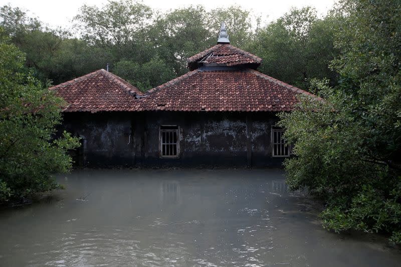 A mosque affected by land subsidence and rising sea level is pictured at Bedono village in Demak regency near Semarang