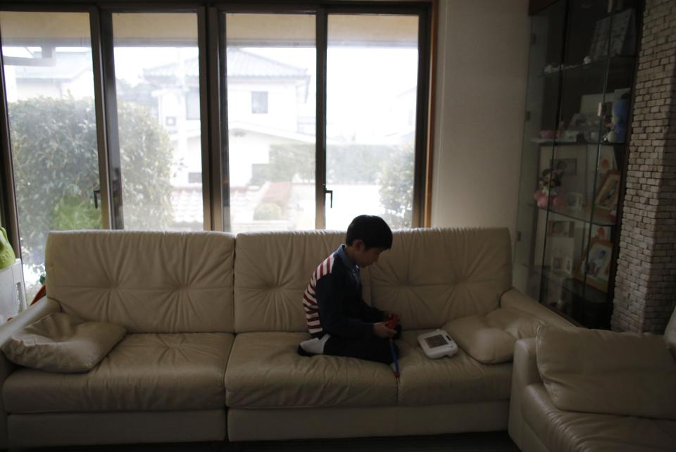Seven-year-old Masyoshi Kaneta plays Nintendo Wii U game at a living room of his home in Koriyama, west of the tsunami-crippled Fukushima Daiichi nuclear power plant, Fukushima prefecture February 28, 2014. (REUTERS/Toru Hanai)