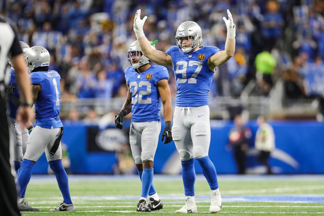 Detroit Lions defensive end Aidan Hutchinson pumps up the crowd before a play against the Green Bay Packers during the second half at Ford Field in Detroit on Thursday, Nov. 23, 2023.