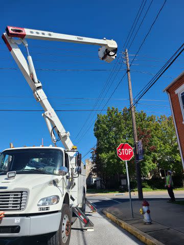 <p>Columbia Borough Police/Facebook</p> PPL Electric Utilities rescuing a cat stuck on a telephone pole in Lancaster County, Pennsylvania