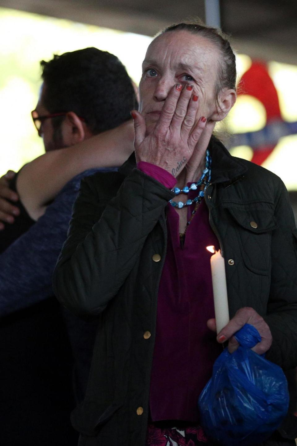 A woman wipes away a tear at a vigil for the victims of the Grenfell disaster (PA)