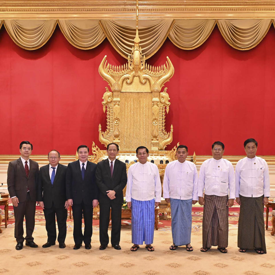 In this photo released from Myanmar Military True News Information Team, Min Aung Hlaing, center right, the head of ruling military council, poses for photo together with Alounkeo Kittikhoun, center left, special envoy of ASEAN Chairman, during their meeting Wednesday, Jan. 10, 2024, in Naypyitaw, Myanmar. A veteran Laotian diplomat recently appointed the Association of Southeast Asian Nations' special envoy to Myanmar, has arrived on his first mission to the strife-torn nation. (The Military True News Information Team via AP)