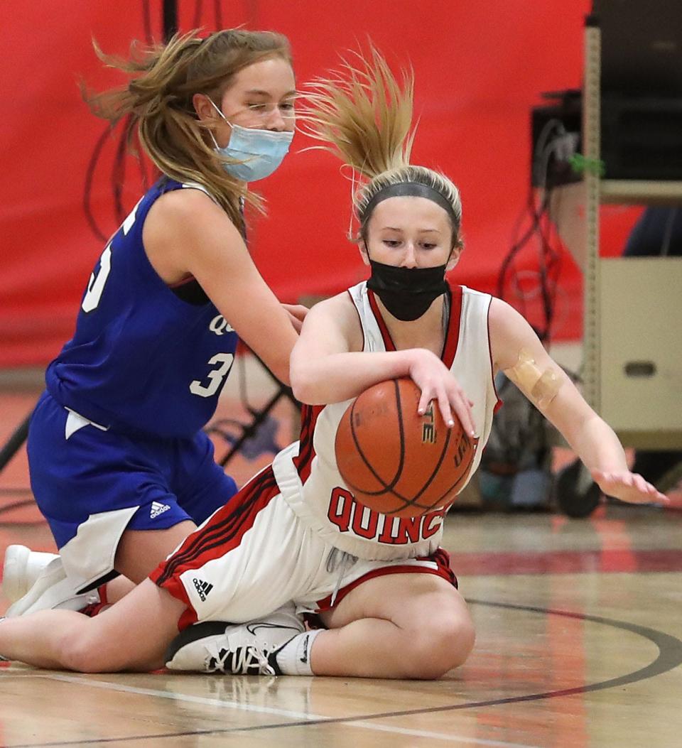 North Quincy's Molly Toland, foreground, works to keep the ball away from Quincy's Caroline Tracey. North Quincy hosted Quincy in girls basketball on Friday, Jan. 21, 2022.