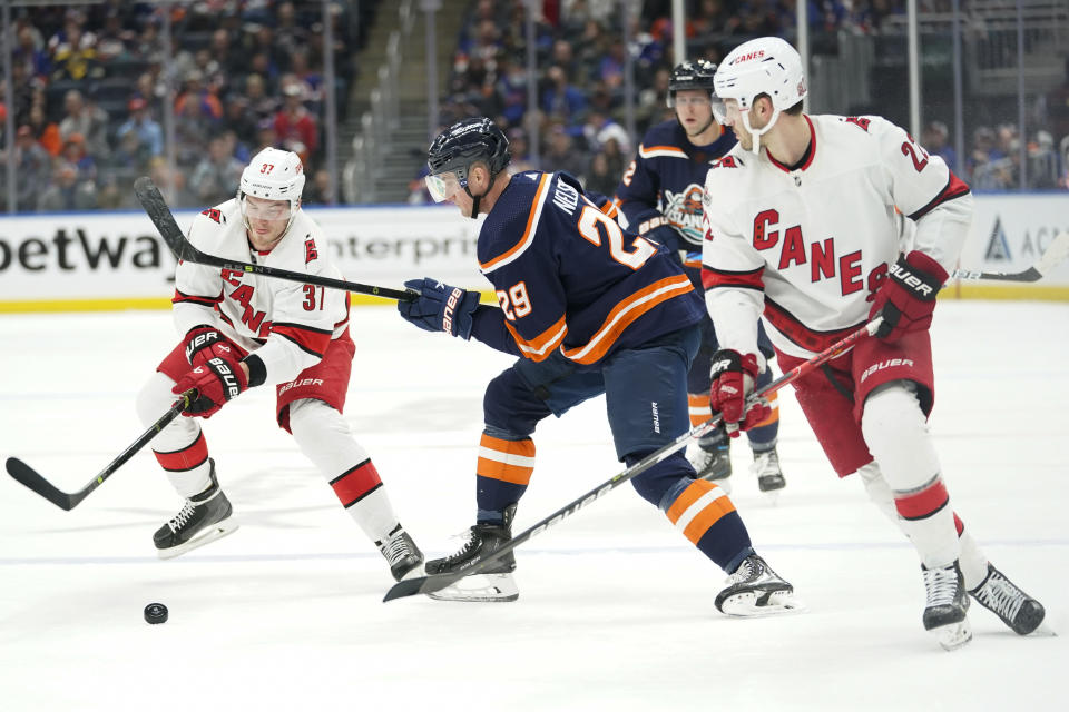 Carolina Hurricanes right wing Andrei Svechnikov (37) skates against New York Islanders center Brock Nelson (29) during the second period of an NHL hockey game, Saturday, Dec. 10, 2022, in Elmont, N.Y. (AP Photo/Mary Altaffer)