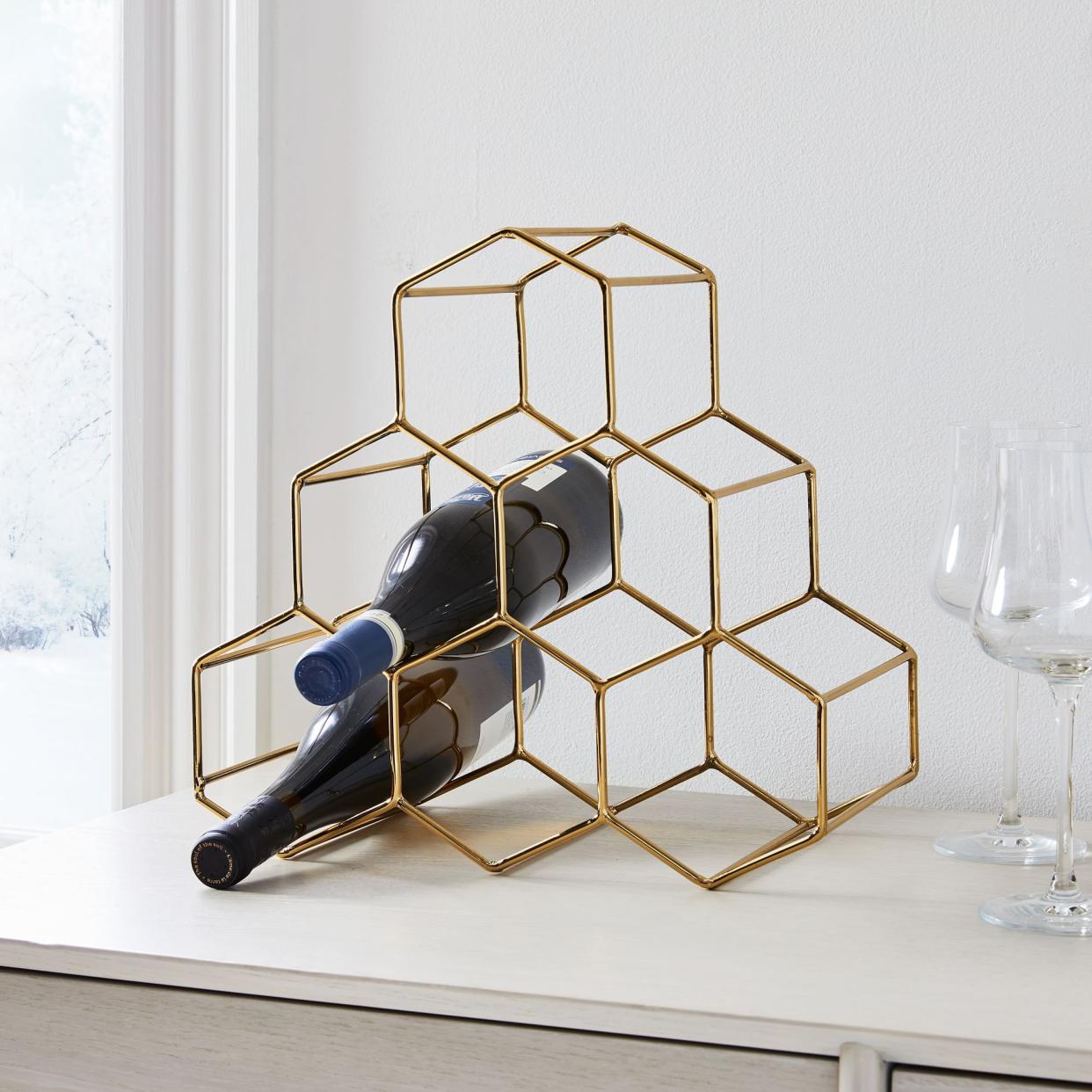 <p><a href="https://go.redirectingat.com?id=74968X1596630&url=https%3A%2F%2Fwww.westelm.com%2Fproducts%2Fhoneycomb-wine-rack-d9061&sref=https%3A%2F%2Fwww.delish.com%2Fholiday-recipes%2Fg2582%2Fwine-gifts%2F" rel="nofollow noopener" target="_blank" data-ylk="slk:Shop Now;elm:context_link;itc:0;sec:content-canvas" class="link rapid-noclick-resp">Shop Now</a></p><p>Honeycomb Metal Wine Rack</p><p>West Elm</p><p>$39.99</p>