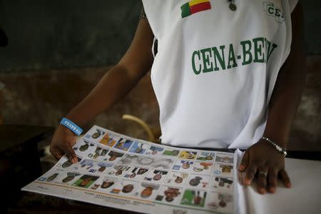 An electoral officer prepares voting materials during a presidential election at a polling station in Cotonou, Benin, March 6, 2016. REUTERS/Akintunde Akinleye