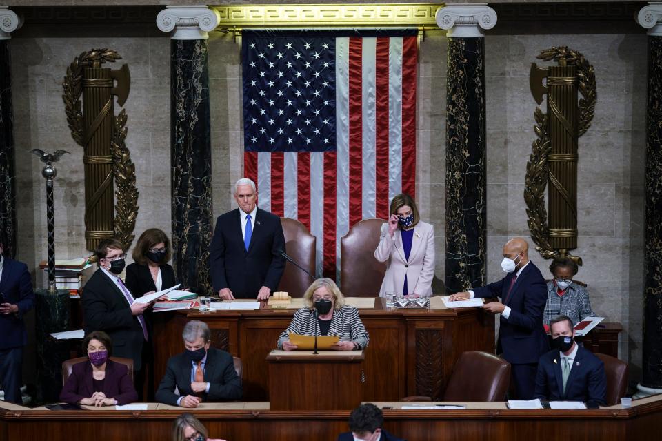 Vice President Mike Pence and Speaker of the House Nancy Pelosi, D-Calif., prepare to read the final certification of Electoral College votes cast in November's presidential election during a joint session of Congress after working through the night, at the Capitol on January 7, 2021 in Washington, D.C.