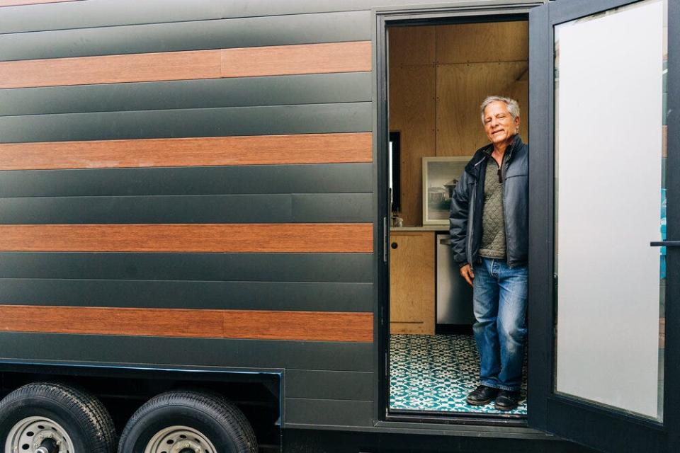 Architect and urban planner Andres Duany stands in the doorway of one of the tiny homes designed through his No Nonsense Housing Company. Duany, who designed Seaside in Walton County, is looking at tiny homes as a possible solution to the county's struggle to provide affordable housing to the local workforce.