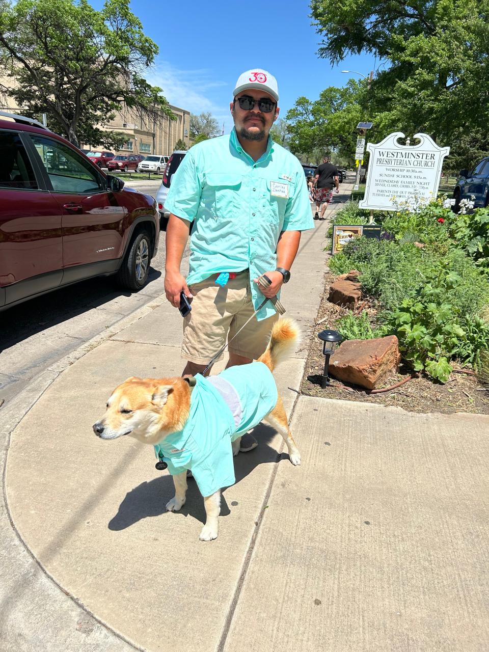 Carlos Rodriguez is shown with his Look-a-like winner, Dantes. The two had matching outfits for the Westminster Doggy Show at the Church by Austin Park held Saturday. Dantes was saved from a dire situation by his new owner Carlos and his wife, Perla Rodriguez.