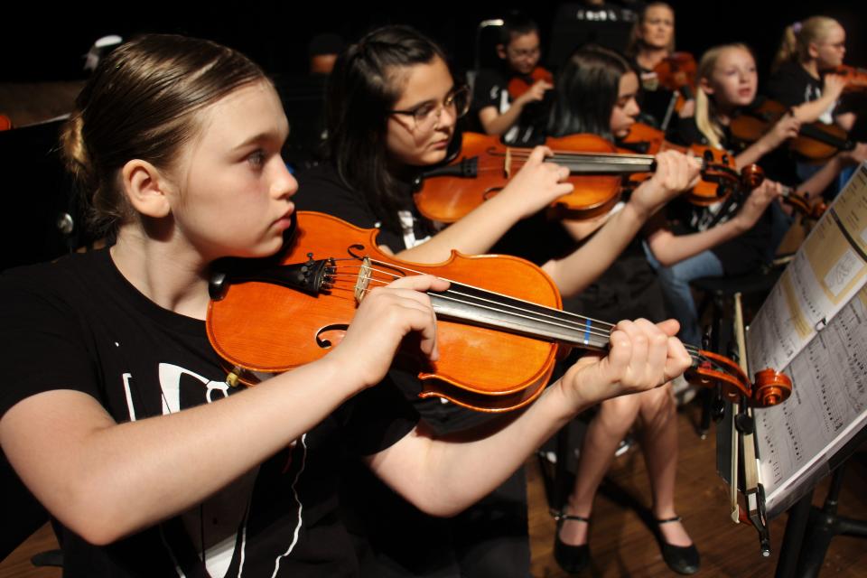 Violinists work through a section in "Seminole Chant," a piece they were prepping for a Mission Strings 1 performance. April 2 2023