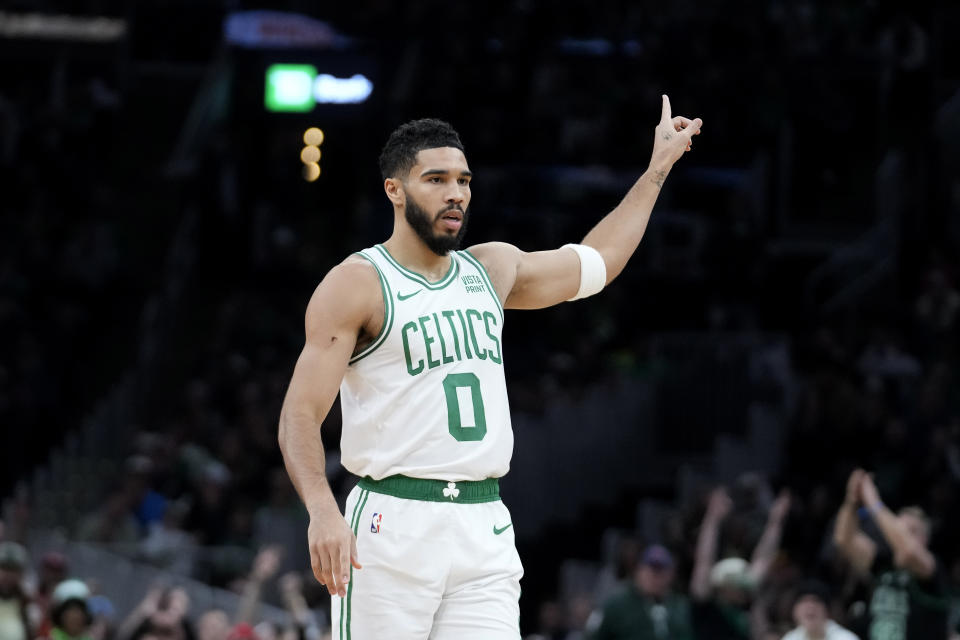 Boston Celtics forward Jayson Tatum (0) points up after scoring against the Atlanta Hawks in the first half of an NBA basketball game, Sunday, Nov. 26, 2023, in Boston. (AP Photo/Steven Senne)