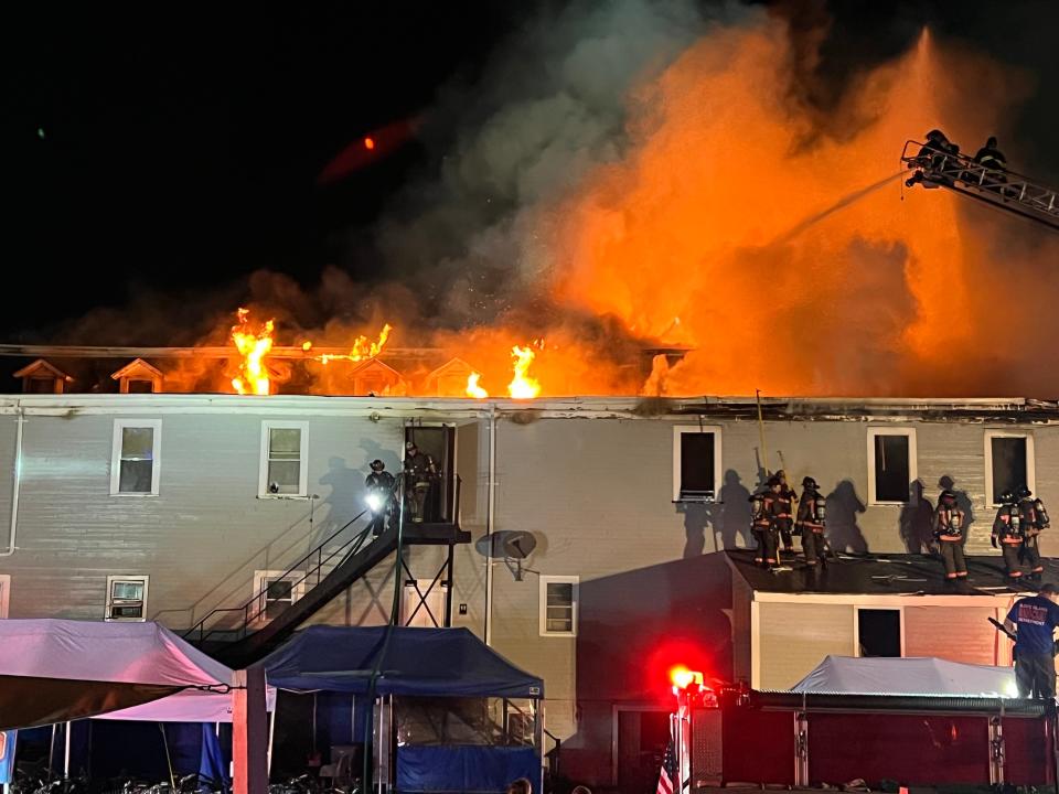 Flames are seen coming out of the roof of the Harborside Inn as crews work to extinguish the fire, believed to have started in the hotel's kitchen.