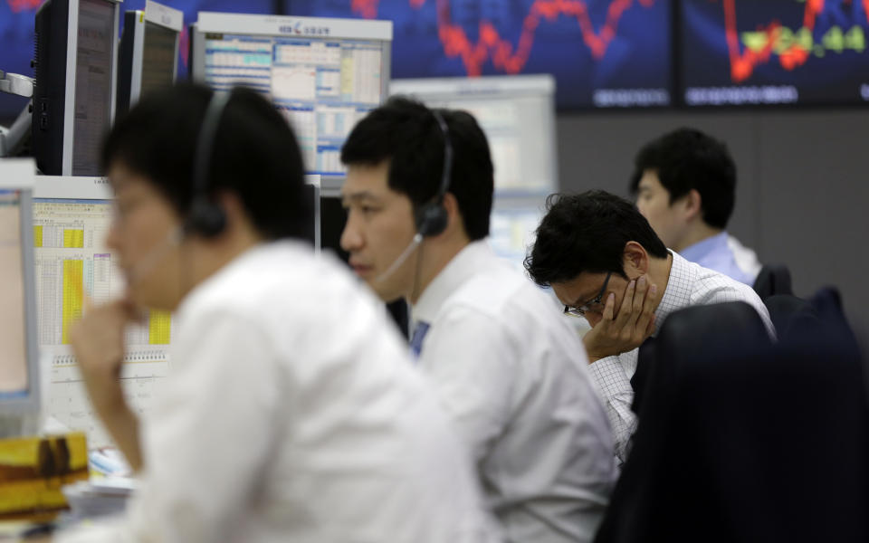 Currency traders work at the foreign exchange dealing room of the Korea Exchange Bank headquarters in Seoul, South Korea, Wednesday, Oct. 10, 2012. Worries about Europe's debt crisis, signs of weak global growth and expectations of lower U.S. corporate earnings sent most Asian stock markets down Wednesday. South Korea's Kospi dropped 1.4 percent at 1,955.84. (AP Photo/Lee Jin-man)