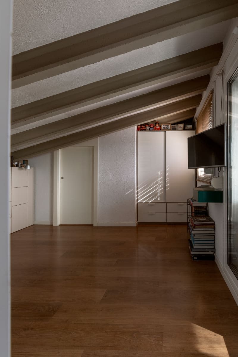 Television and storage unit in neutral toned room.