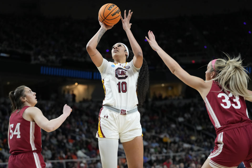 South Carolina center Kamilla Cardoso (10) puts up a shot against Indiana guard Sydney Parrish (33) and forward Mackenzie Holmes (54) during the first quarter of a Sweet Sixteen round college basketball game during the NCAA Tournament, Friday, March 29, 2024, in Albany, N.Y. (AP Photo/Mary Altaffer)