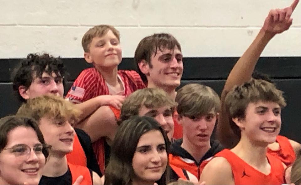 Senior center Hank Alvey celebrates with teammates and fans after Illini Bluffs beat Camp Point Central, 47-35, in the IHSA Class 1A boys Abingdon Sectional championship game on Friday, March 1, 2024.