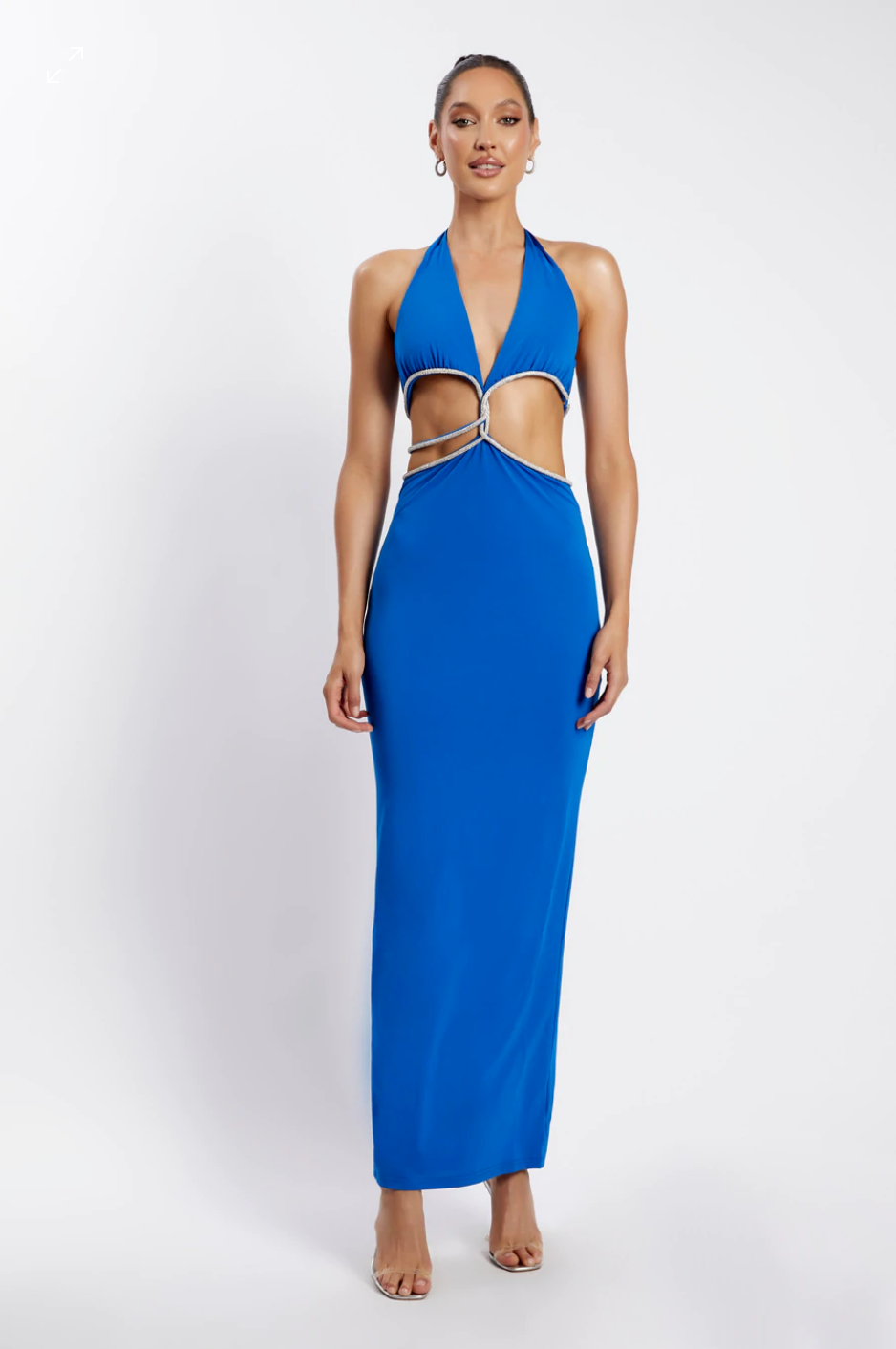 A woman with dark hair tied back wears a azure halter neck MESHKI NICHA Diamante Cut Out Midi Dress - $189