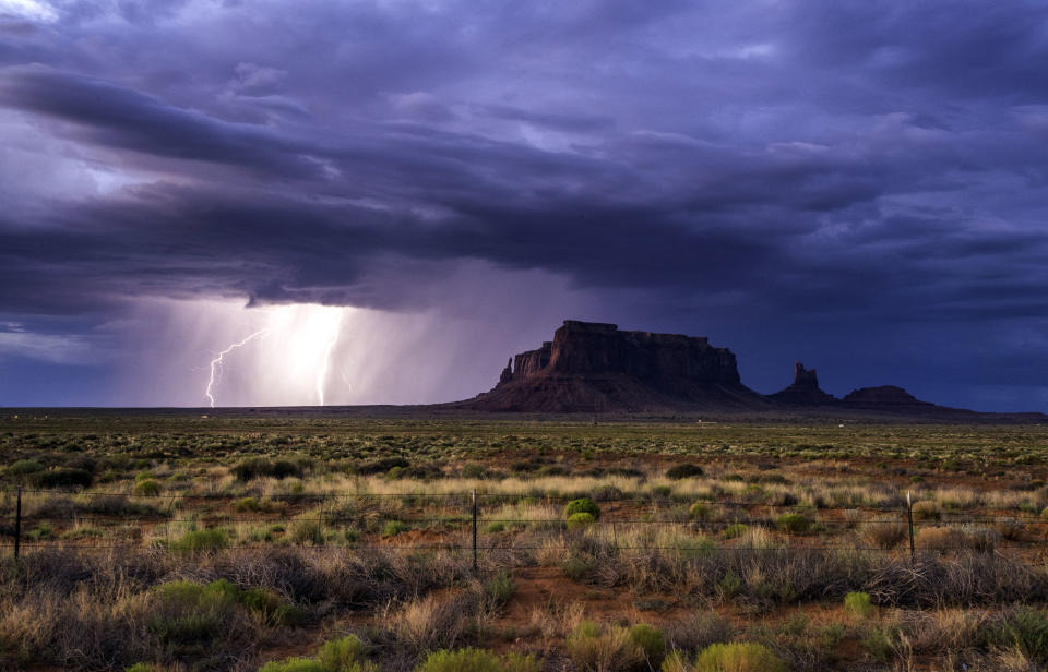 <p>Rain and lightning bolts hammer the desolate terrain of Monument Valley, Ariz. (Photo: Jennifer Khordi/Caters News) </p>