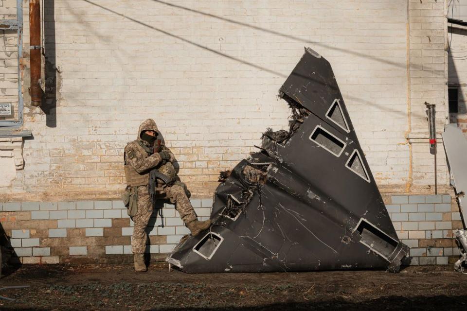A Ukrainian soldier poses for a camera next to the wreckage of a Russian kamikaze drone shot down over Kyiv Oblast, Ukraine, on March 31, 2024. (Zinchenko/Global Images Ukraine via Getty Images)