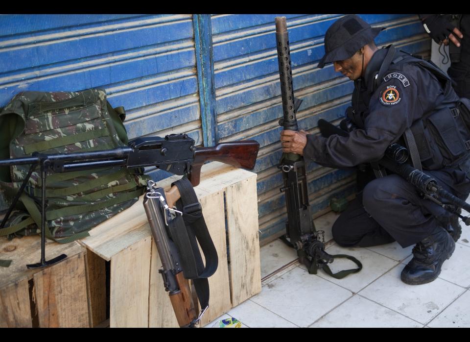 Brazil has <a href="http://www.foxnews.com/world/2011/04/09/brazil-debates-gun-laws-deadly-school-shooting/" target="_hplink">strict gun laws</a>. Gun holders need to be 25, have no criminal record and attend safety courses. Licences are granted for reasons of hunting, target shooting, personal protection and security and must be renewed every three years.     <em>Caption: A policeman holds a seized  machine gun at Morro do Alemao shanty town on November 28, 2010 in Rio de Janeiro, Brazil. (JEFFERSON BERNARDES/AFP/Getty Images)</em>