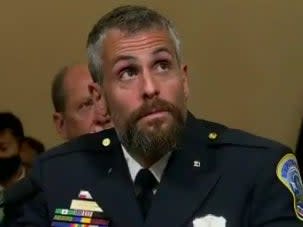 Capitol Police Officer Michael Fanone watches footage of the 6 January insurrection during the House select committee hearing on the Capitol riot. (screengrab)