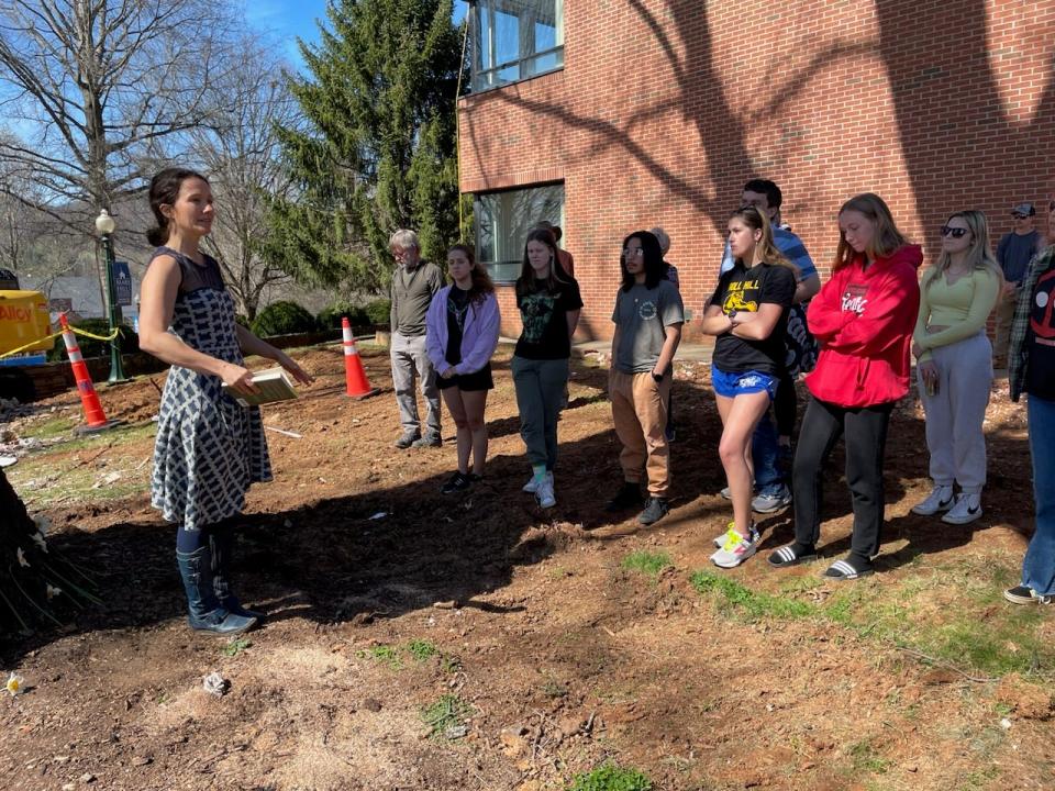 Mars Hill University professor Laura Boggess helped to organize a meeting for university faculty and students to join with residents to grieve the loss of 10 trees the university administration is planning to cut down as part of its new student center construction.