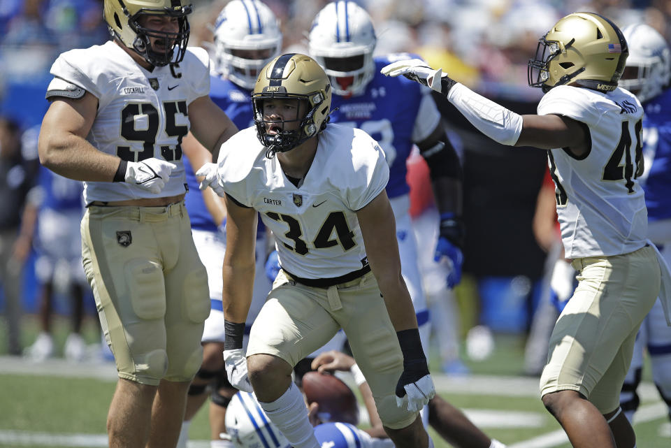 FILE - Army linebacker Andre Carter II (34) celebrates after sacking Georgia State quarterback Cornelious Brown IV (4) during the first quarter of an NCAA football game Saturday, Sept. 4, 2021, in Atlanta. Army features a roster that returns standout linebacker Andre Carter, who posted 15.5 sacks, second nationally. (AP Photo/Ben Margot, File)