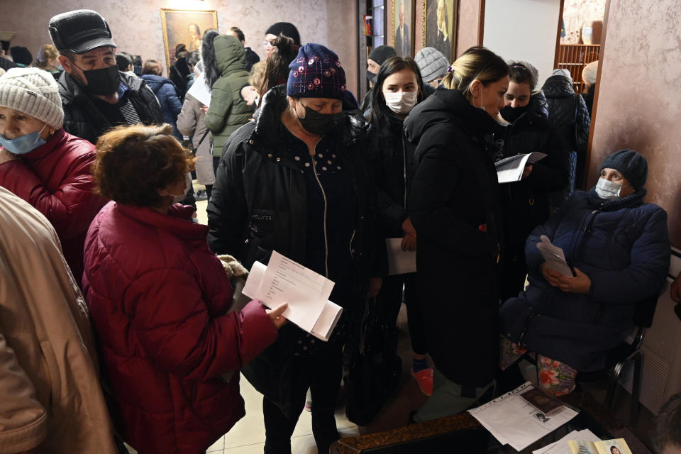 People from Donetsk, the territory controlled by a pro-Russia separatist government in eastern Ukraine, gather to fill in documents after evacuating in the Rostov-on-Don region, near the border with Ukraine, Russia, Sunday, Feb. 20, 2022. Russia is extending military drills near Ukraine’s northern borders after two days of sustained shelling along the contact line between Ukrainian soldiers and Russia-backed separatists in eastern Ukraine. The exercises in Belarus, which borders Ukraine to the north, originally were set to end on Sunday. (AP Photo)