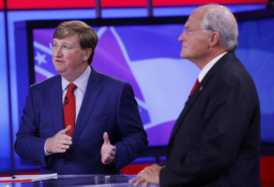 Lt. Gov. Tate Reeves, left, answers a question as his GOP gubernatorial runoff opponent former Mississippi Supreme Court Chief Justice Bill Waller Jr., listens during their televised debate in Jackson, Miss., Wednesday, Aug. 21, 2019. (AP Photo/Rogelio V. Solis)