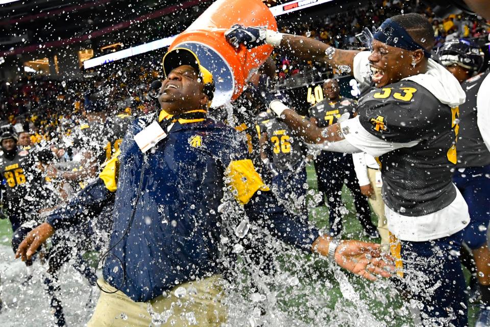 In this Dec. 21, 2019, file photo, North Carolina A&T coach Sam Washington is doused by defensive back Jalon Bethea during the final seconds of the Celebration Bowl NCAA college football game against Alcorn State, in Atlanta. Teams in the SWAC as well as many other HBCUs across the country play in the Football Championship Subdivision (FCS).