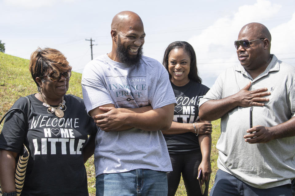 John Miller, center, smiles with his family, Velma Miller, left, mother, Kalita Miller, sister, and brother Lamont Washington, outside the SCI Mahanoy State Correctional Institution in Frackville, Pa. Wednesday, July 31, 2019.  Miller spent more than two decades behind bars for a murder he didn&#39;t commit,  is a free man. The Philadelphia District Attorney&#39;s Office agreed with Miller&#39;s defense team that his prosecution was flawed and his conviction shouldn&#39;t stand.  (Jose F. Moreno/The Philadelphia Inquirer via AP)