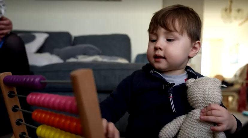 Teddy Hobbs, Britain's youngest Mensa member at just 4, plays with an abacus. / Credit: BBC