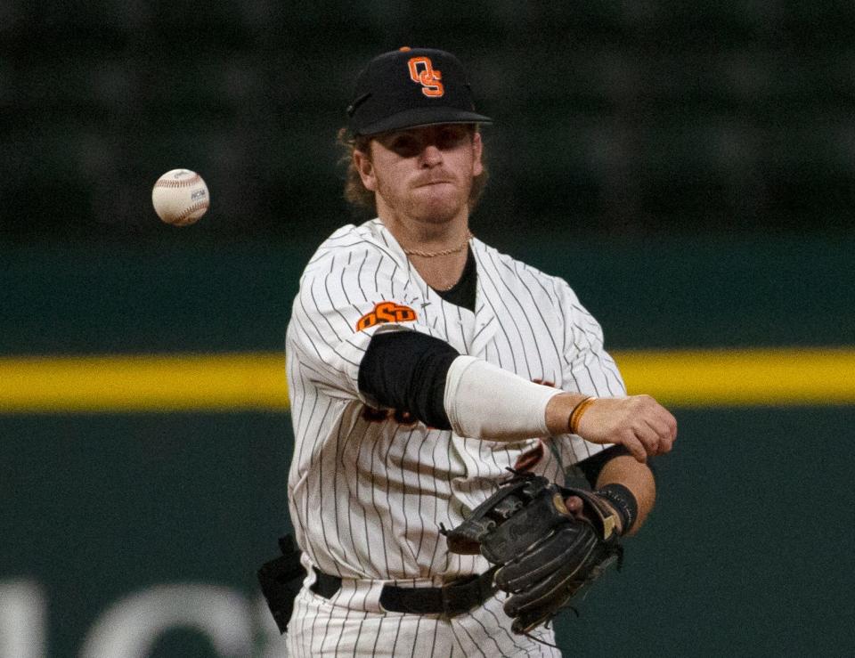 Oklahoma State's Roc Riggio throws to first base against Texas on May 25 in the Big 12 tournament at Globe Life Field in Arlington. Texas.