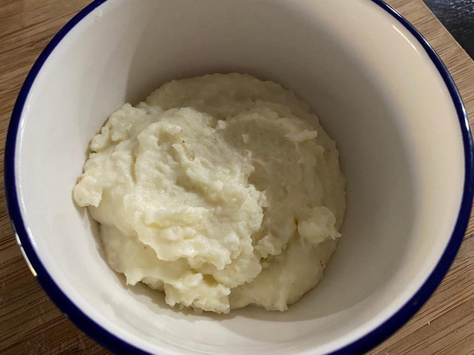 Mashed potatoes in a white bowl.