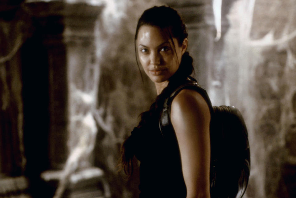 Angelina Jolie stands in a catacomb