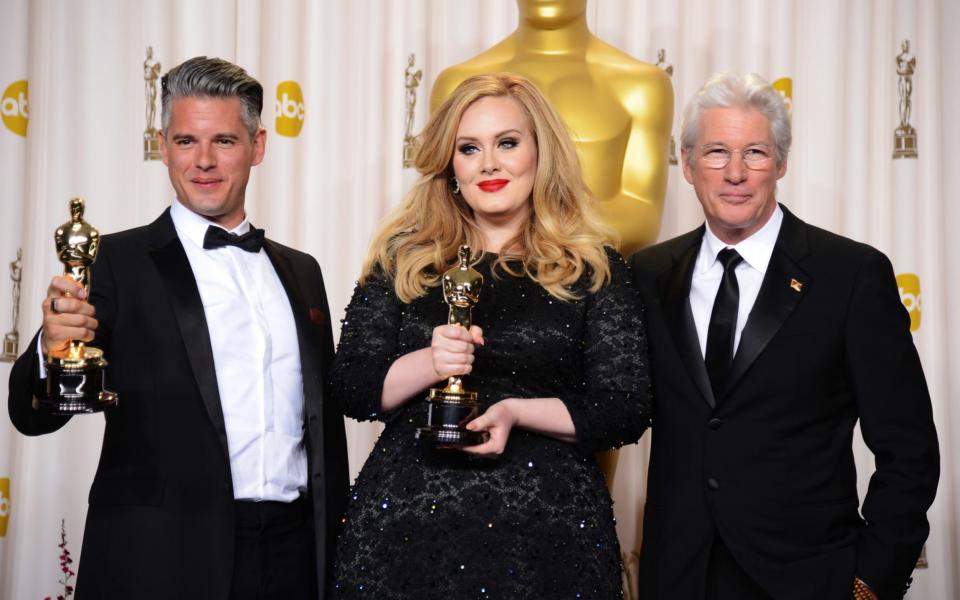 Paul Epworth and Adele (joined by Richard Gere) picking up their Oscar for Skyfall, in 2013 - Getty 