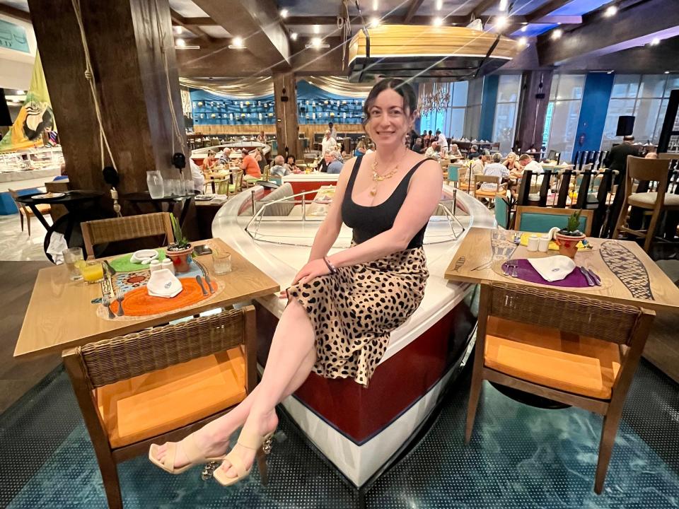 simone sitting on a speedboat table in a restaurant at Margaritaville cancun