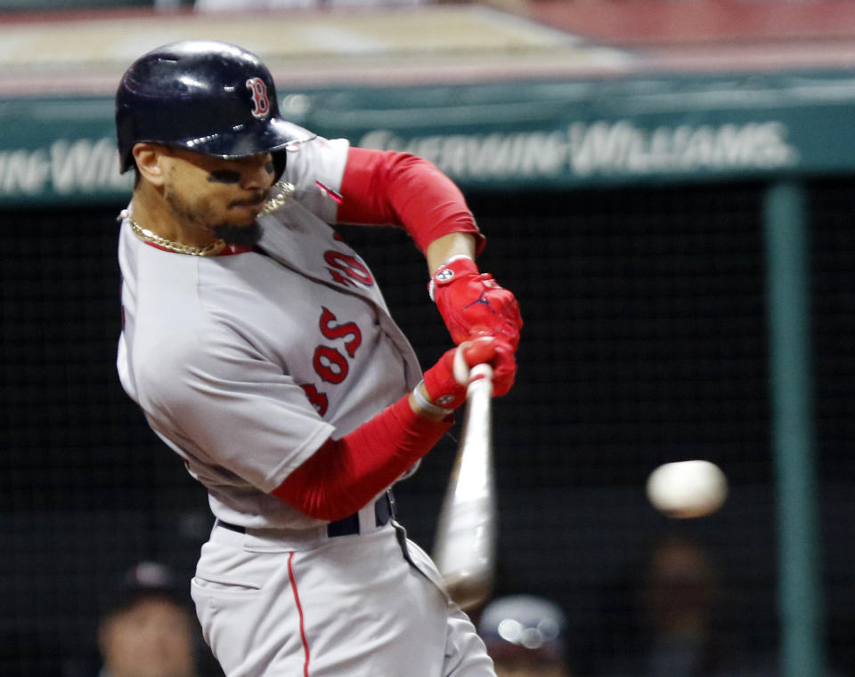 Mookie Betts hits a double in the seventh inning Sunday against the Cleveland Indians. (AP)