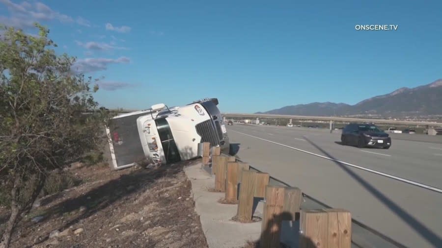 A semi-truck toppled over due to the Santa Ana winds in the eastbound lanes of the 210 Freeway in Fontana. The truck is seen on March 15, 2024. (On Scene.TV)