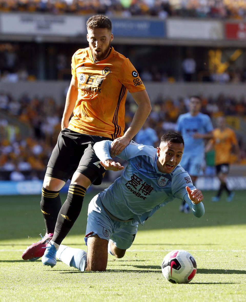 Wolverhampton Wanderers's Matt Doherty, left, and Burnley's Dwight McNeil battle for the ball during the English Premier League soccer match Between Burnley and Wolverhampton Wanderers at Molineux, Wolverhampton, England, Sunday Aug. 25, 2019. (Darren Staples/PA via AP)