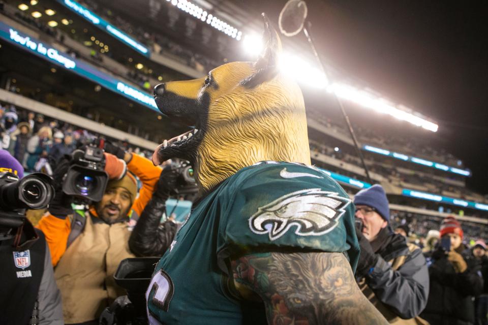 Eagles' Chris Long, 56, wears a dog mask into the tunnel after defeating the Atlanta Falcons 15-10 in January 2018.