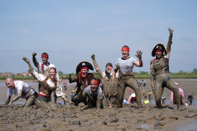 Competitors take part in the annual Maldon Mud Race, a charity event to race across the bed of the River Blackwater in Maldon, Essex