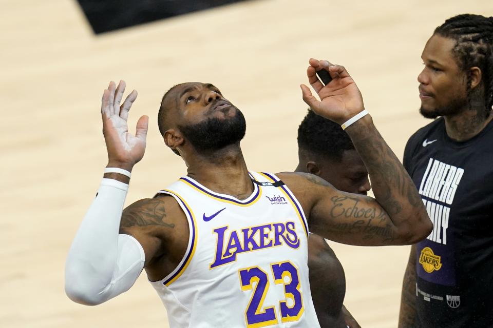 Los Angeles Lakers forward LeBron James looks up after tossing chalk in the air prior to Game 1 of their NBA basketball first-round playoff series against the Phoenix Suns Sunday, May 23, 2021, in Phoenix. (AP Photo/Ross D. Franklin)