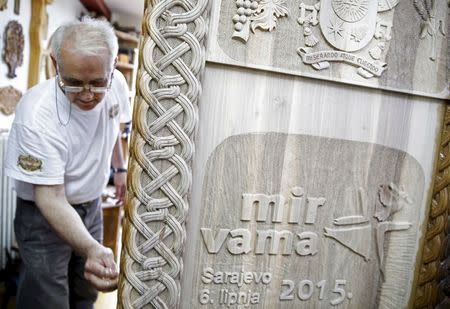 Bosnian wood carver-sculptor Salem Hajderovac works on a chair for Pope Francis, at his workshop in Zavidovici, Bosnia and Herzegovina, in this May 25, 2015 file photo. Even before arriving in Sarajevo, Pope Francis has achieved a remarkable feat. Preparing for the visit, Bosnians of all faiths are showing a rare unity in a country plagued by political and ethnic tensions nearly 20 years after the end of its 1992-95 war that claimed over 100,000 lives. While the pontiff's June 6 visit is the most eagerly awaited by Catholic Croats, the smallest group in the ethnically segmented state, Orthodox Serbs and Muslim Bosniaks have also taken an active part in preparing a warm welcome for Francis. REUTERS/Dado Ruvic/Files