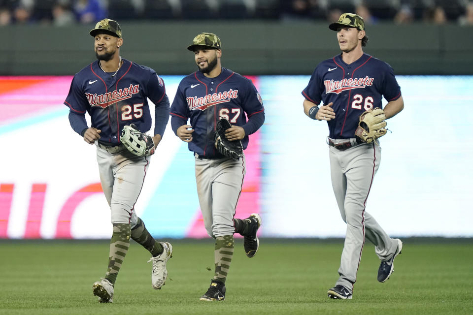 Minnesota Twins outfielders Byron Buxton (25), Gilberto Celestino (67) and Max Kepler (26) celebrate after their baseball game against the Kansas City Royals Friday, May 20, 2022, in Kansas City, Mo. The Twins won 6-4.(AP Photo/Charlie Riedel)