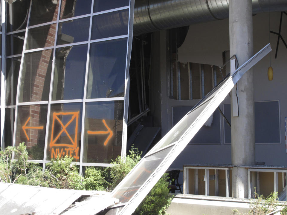 Structural engineers with experience responding to earthquakes and natural disasters are helping experts at the University of Nevada, Reno with efforts to rebuild this dormitory, in Reno, Nev., Thursday, July 11, 2019, where a natural gas explosion blew out walls and windows last week. School officials gave members of the media their first up-close look at the exterior and interior damage on Thursday. (AP Photo/Scott Sonner)