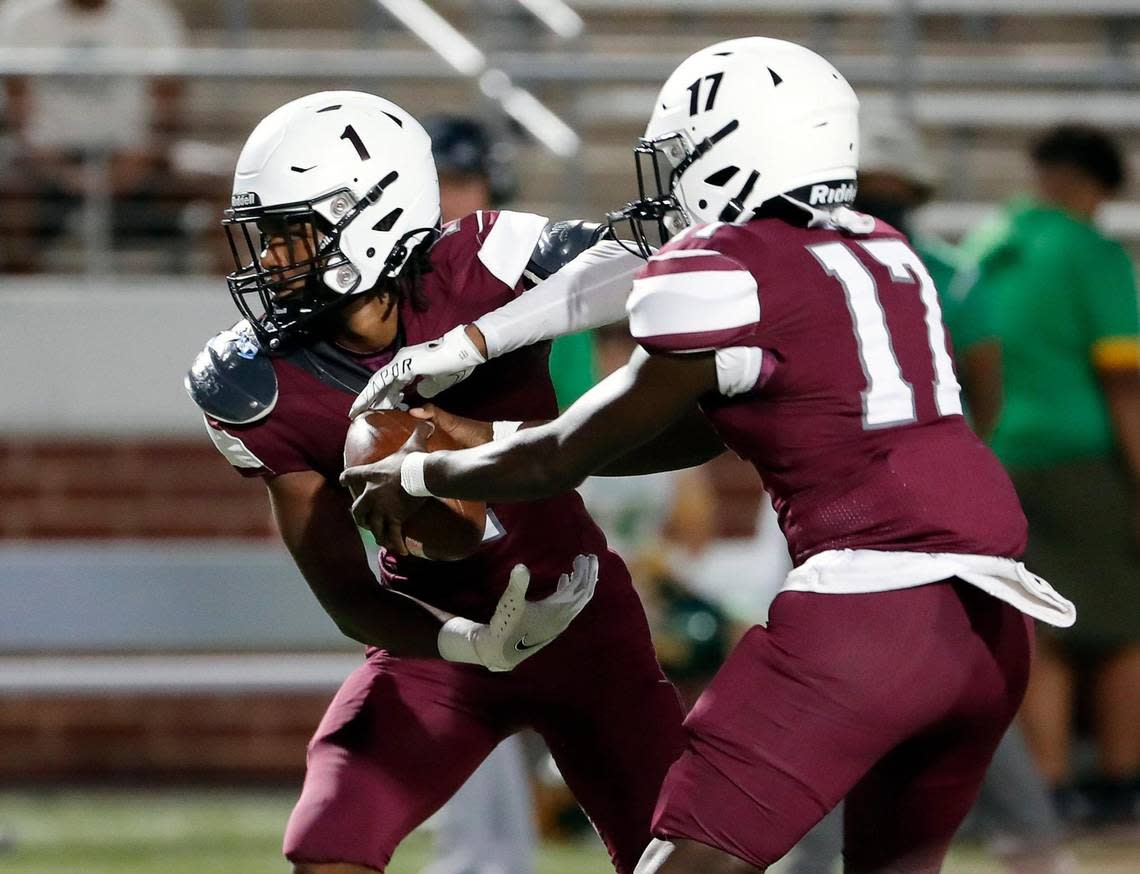 Timberview running back Jarvis Reed (1) takes the handoff from quarterback Zuric Humes (17) in the first half of a high school football game at Vernon Newsom Stadium in Mansfield Texas, Thursday, Sept. 22, 2022. Timberview led Newman Smith 36-8 at the half. (Special to the Star-Telegram Bob Booth)