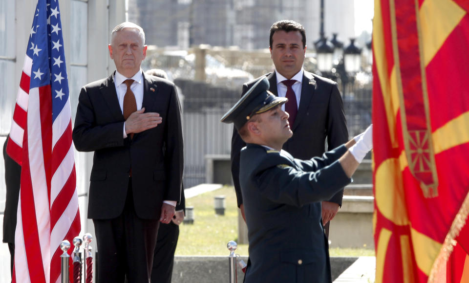 U.S. Defense Secretary James Mattis, left, and Macedonian Prime Minister Zoran Zaev, top right, observe the national anthems during a welcome ceremony at the government building in Skopje, Macedonia, Monday, Sept. 17, 2018. Mattis arrived in Macedonia Monday, condemning Russian efforts to use its money and influence to build opposition to an upcoming vote that could pave the way for the country to join NATO, a move Moscow opposes. (AP Photo/Boris Grdanoski)