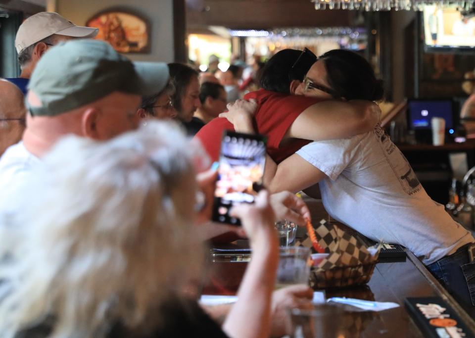 Angela LoBianco-Barone, co-owner of Hyde Park Brewing Company, gets a hug from a patron at the bar on June 15, 2022. LoBianco-Barone announced through a Facebook post that they will cease operation on June 18.